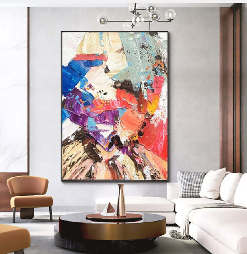 a living room with a large painting on the wall