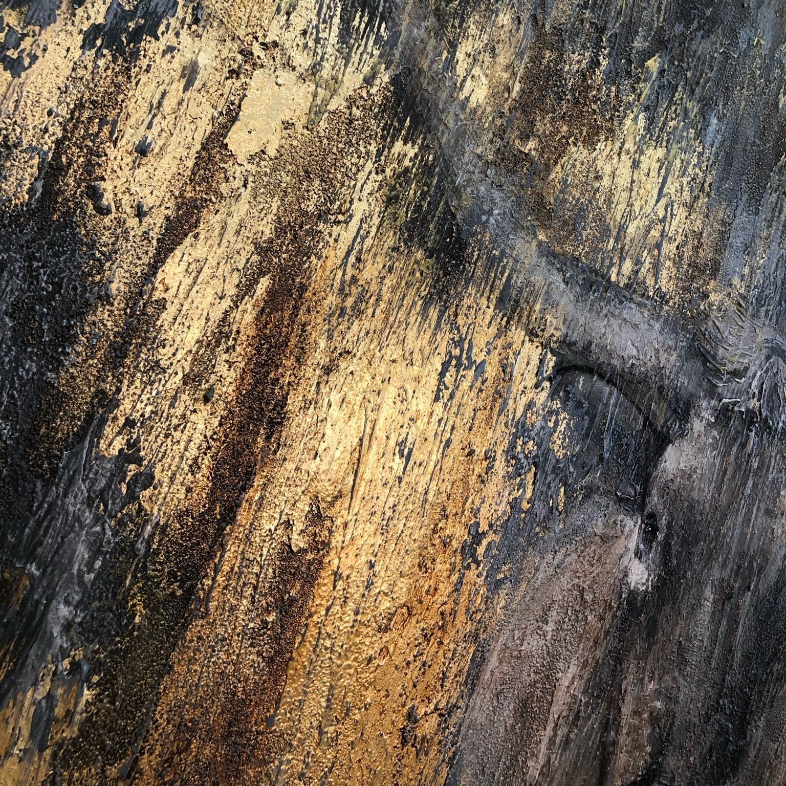 The image is a close-up of a textured surface with a mix of black, gold, and brown colors. The surface appears to be a wooden or metal material, with a rough, textured appearance. The colors are vibrant and contrasting, creating a visually striking image.