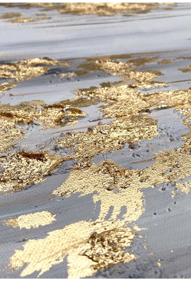 a close up of a wet surface with gold paint