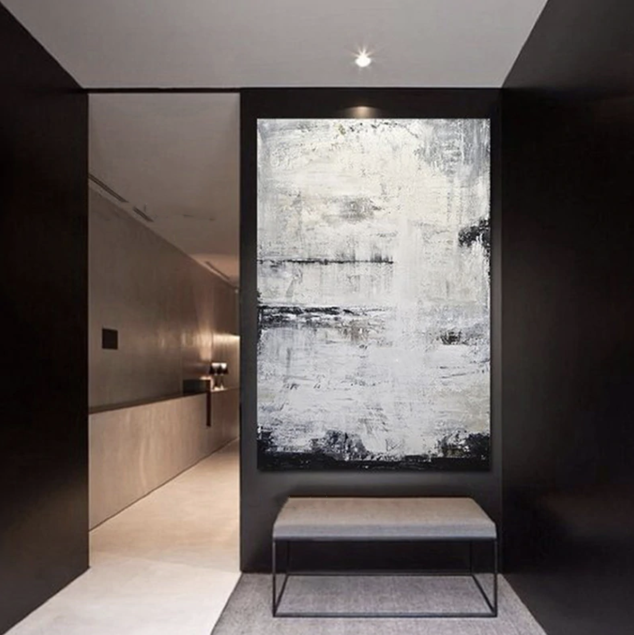 a black and white abstract painting in a hallway