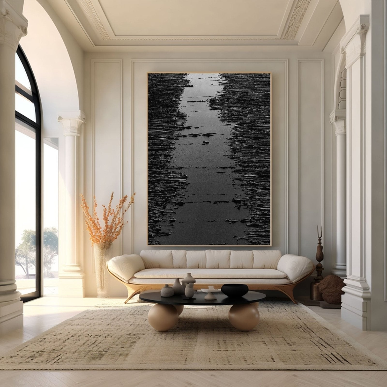a luxurious living room with a large black and white abstract painting on the wall, a white sofa, a coffee table with decorative items, and a large window that allows natural light to fill the space.