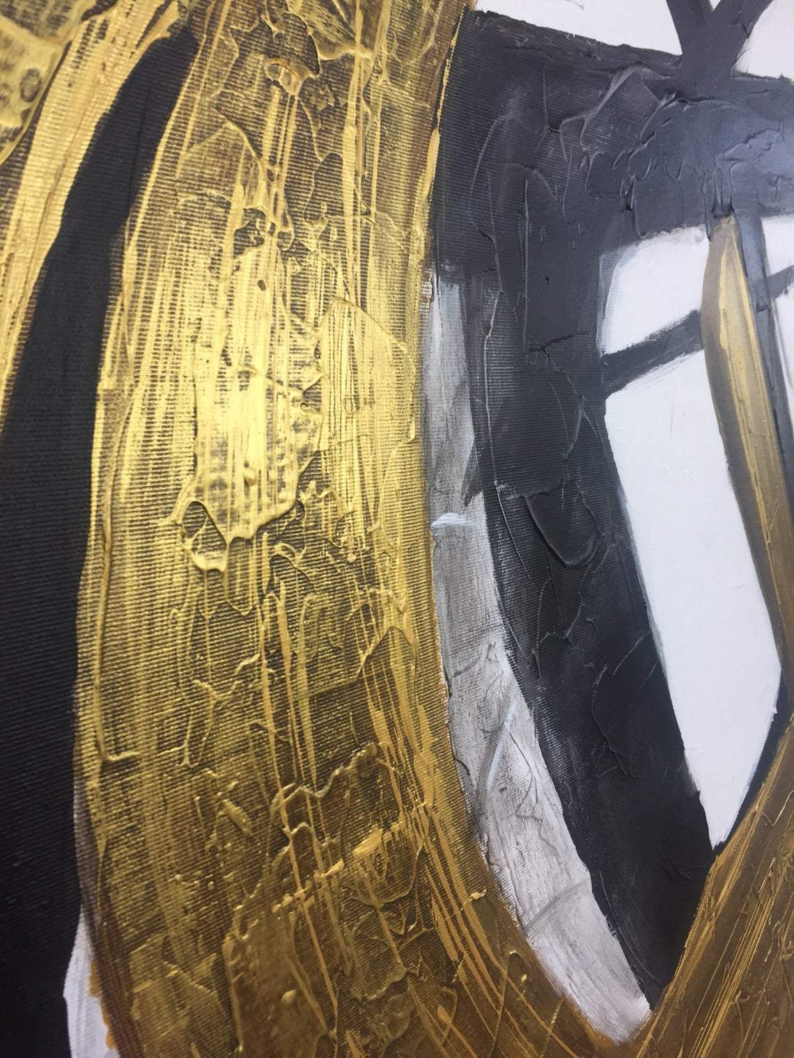 a close up of a painting with gold paint