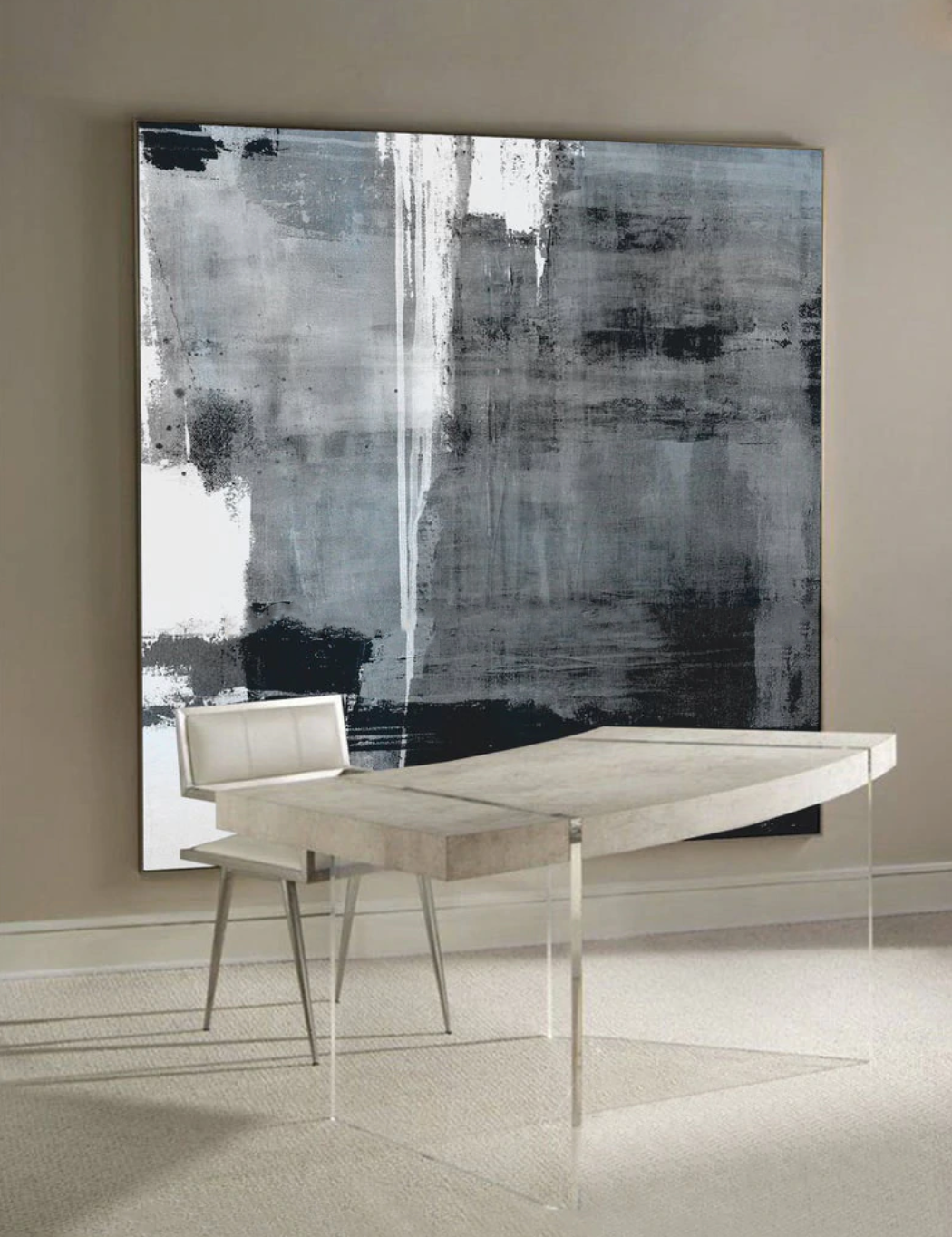 a white table sitting in front of a black and white painting