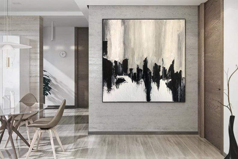 a painting hanging on a wall in a dining room