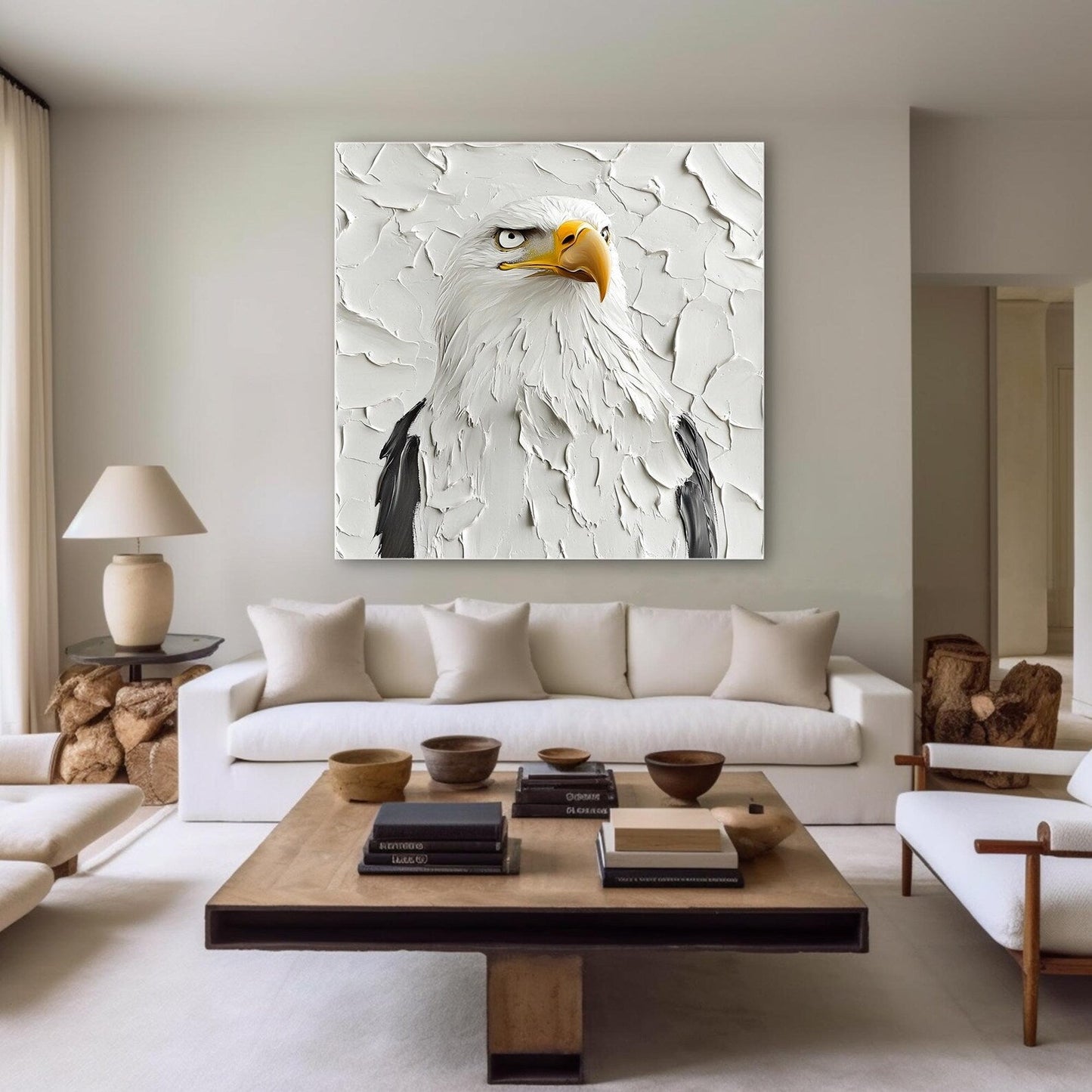 a living room with a white couch and a painting on the wall