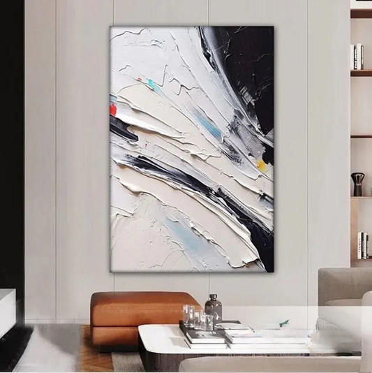 a modern living room with a large abstract painting hanging on the wall. The painting has a white background with black and red stripes, creating a striking contrast. In front of the painting, there is a glass coffee table with a vase and a bottle on it. The room also includes a couch and a bookshelf, adding to the overall aesthetic of the space.