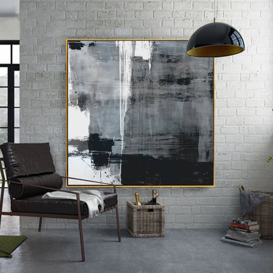 a living room with a chair and a painting on the wall