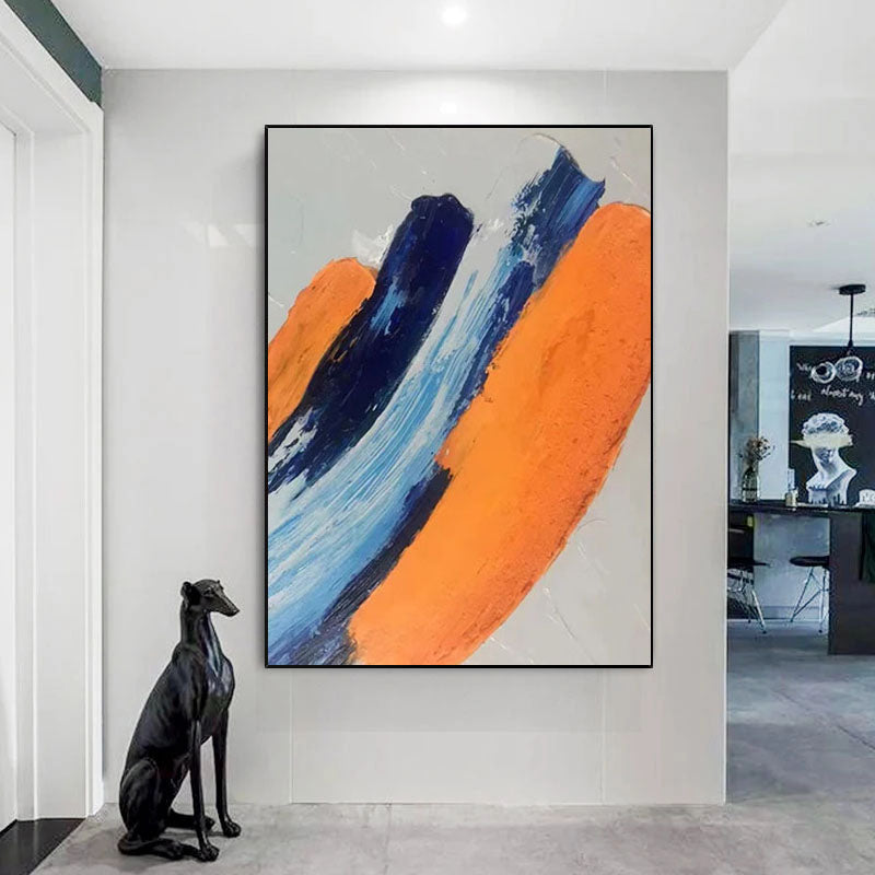 a dog sitting in front of a painting on a wall