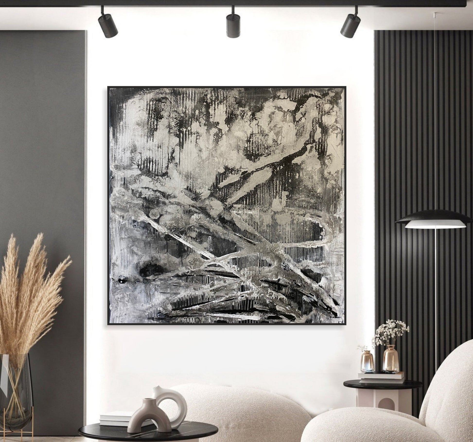 a black and white painting hanging on a wall