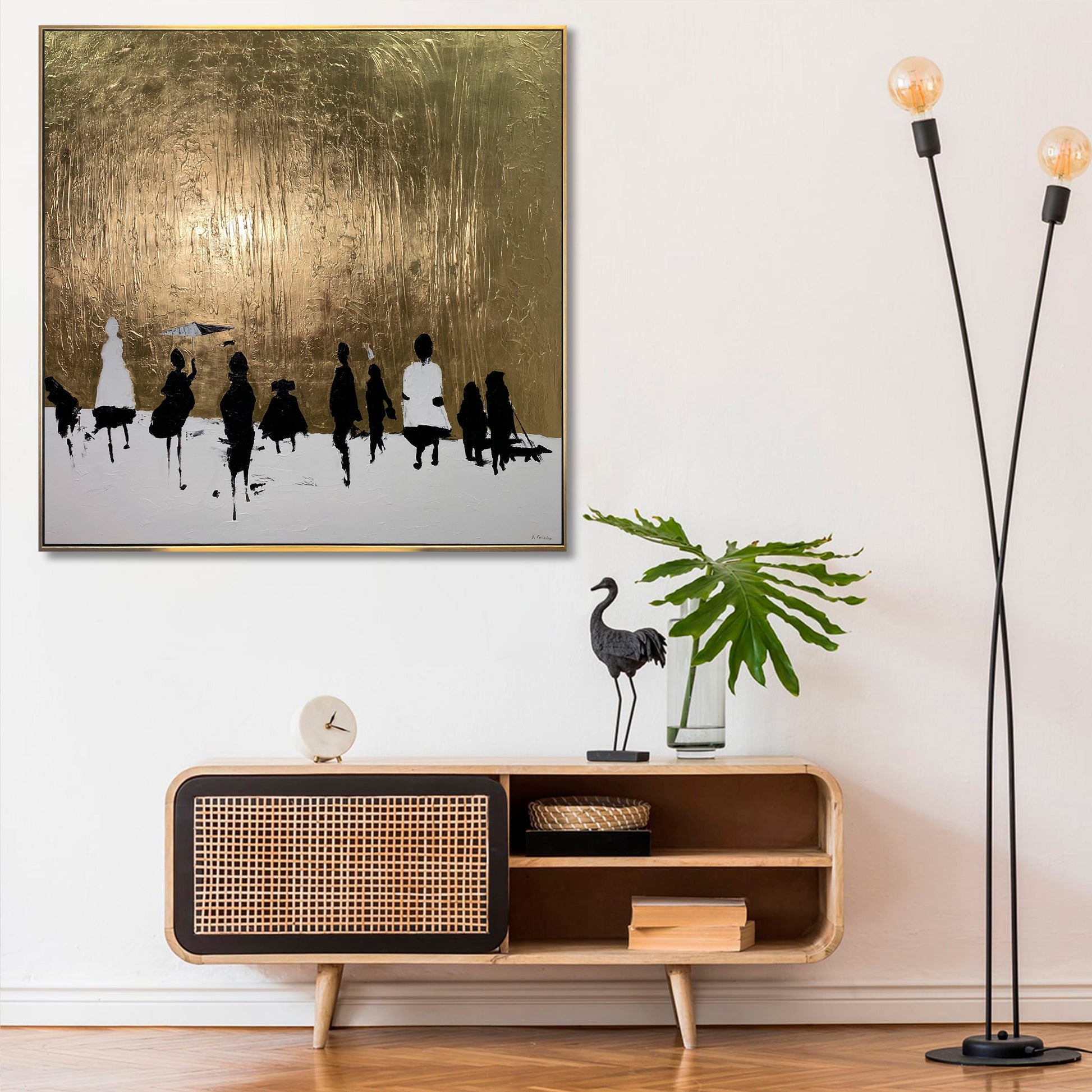 a modern interior design with a large framed artwork depicting a group of people on a snowy landscape, a wooden side table with a clock, a potted plant, and a floor lamp.