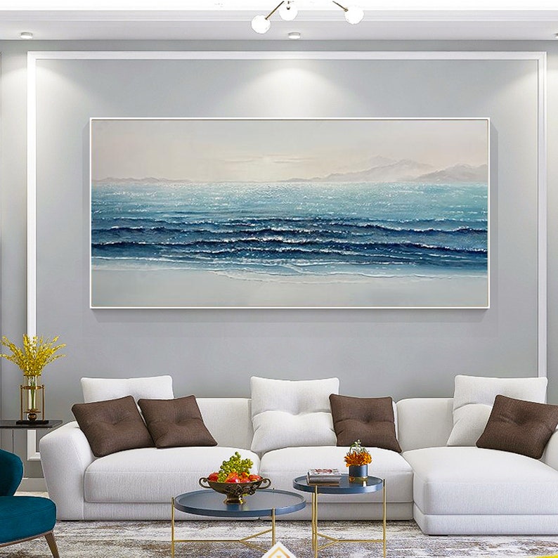 a living room with a large painting on the wall