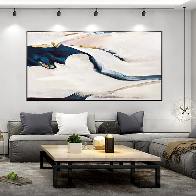 a living room filled with furniture and a painting on the wall