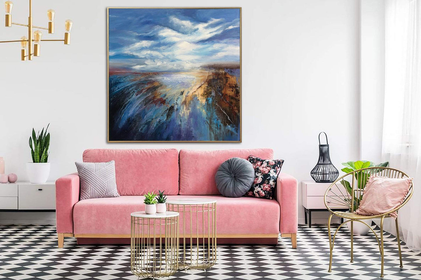 a living room with a pink couch and a painting on the wall