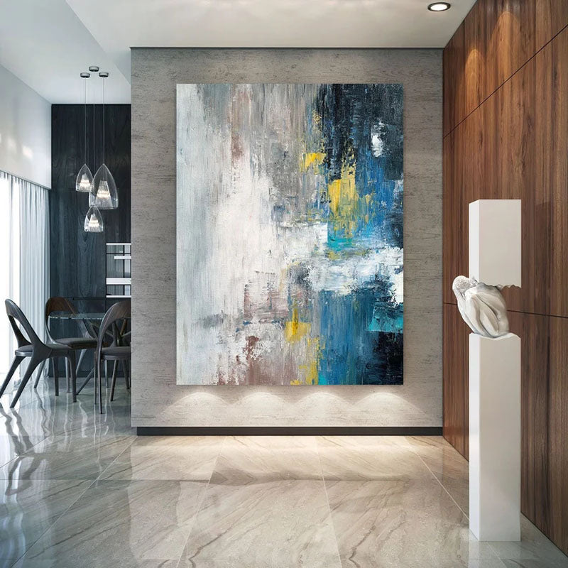 a large abstract painting on a wall in a dining room