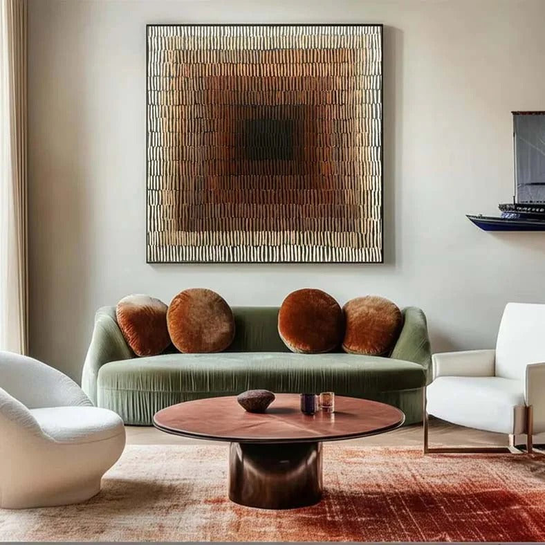 a modern living room with a large abstract painting on the wall, a green sofa with brown throw pillows, a white armchair, and a wooden coffee table.