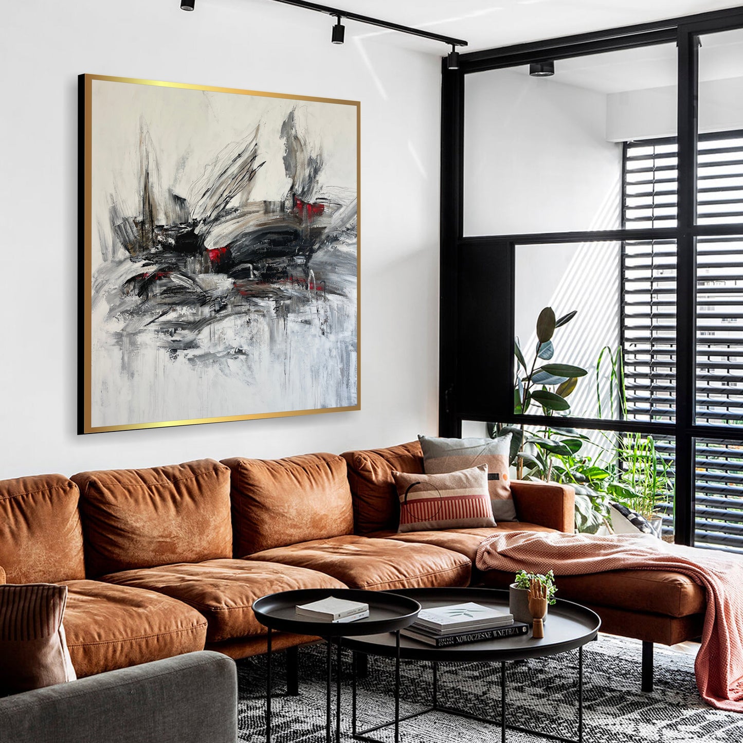 a living room filled with furniture and a painting on the wall