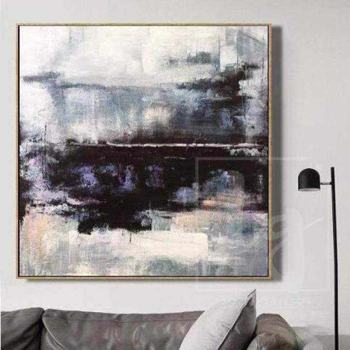 a living room with a couch and a painting on the wall