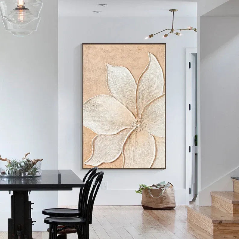a large, abstract floral artwork hanging on a white wall above a wooden dining table with black chairs.