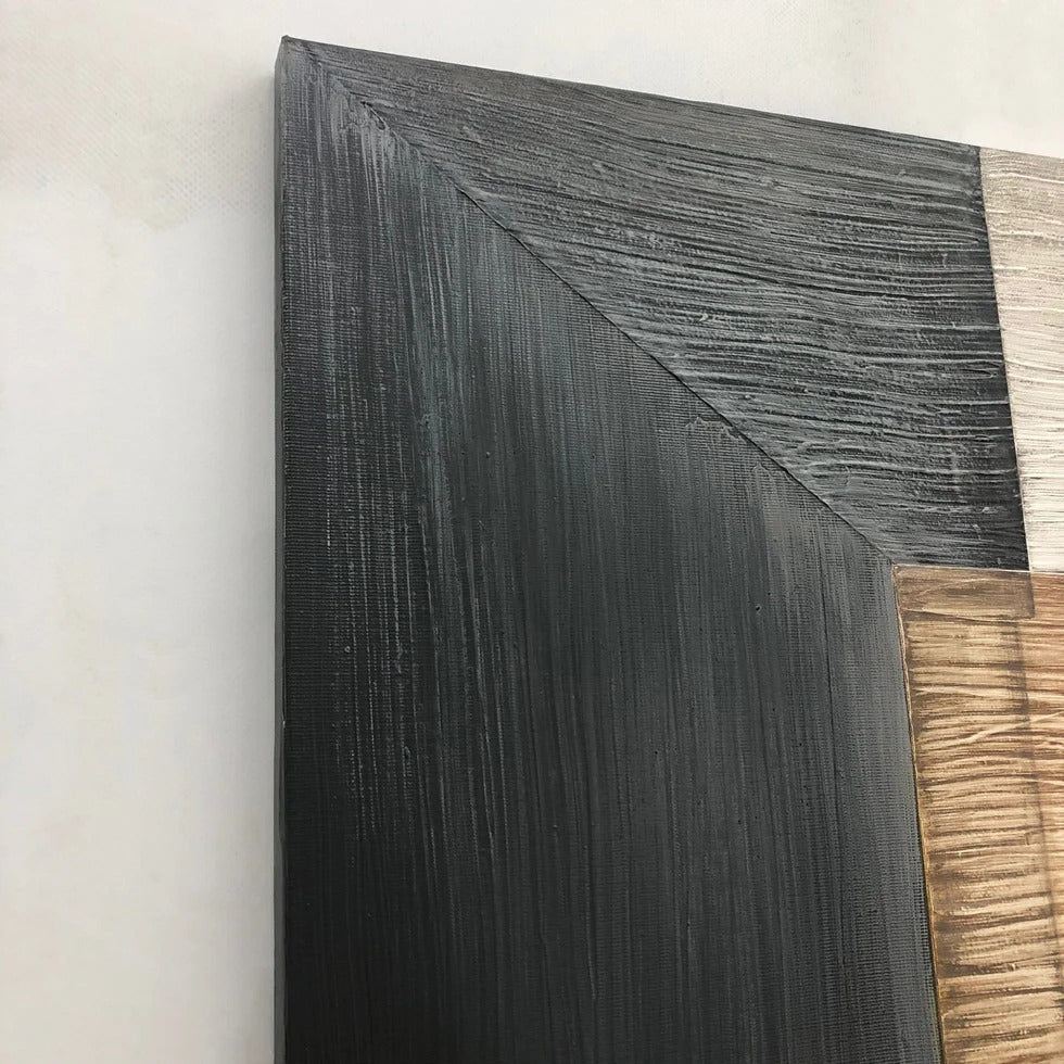 a close-up view of a black, textured surface with a wooden element on the right side.