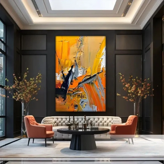 a modern living room with a large abstract painting on the wall, a white sofa, two orange armchairs, and a round coffee table. The room has a high ceiling with recessed lighting and a skylight, creating a bright and airy atmosphere.