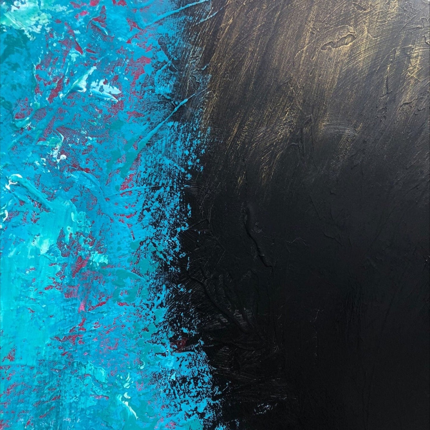 The image is an abstract painting with a striking contrast between blue and black colors. The blue areas are more vibrant and appear to be splattered or dripping, while the black areas have a more textured and rough appearance. The painting has a dynamic and energetic feel, with the colors and textures creating a sense of movement and depth.