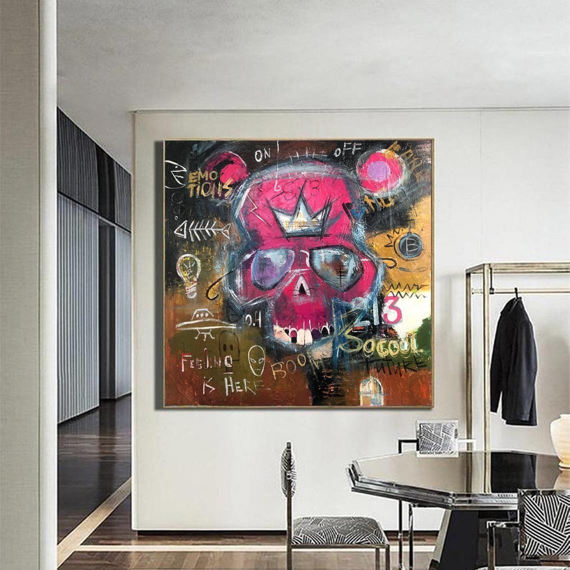 a large, colorful painting of a skull with a crown on it, hanging on a wall in a room.