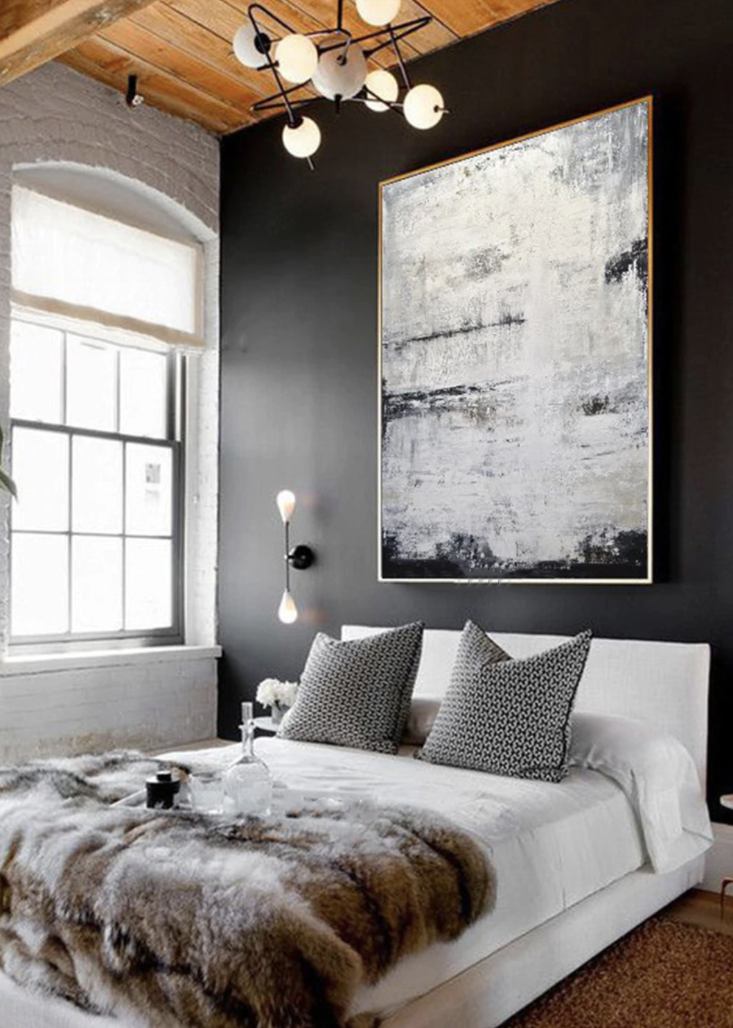 a bedroom with black walls and a white bed