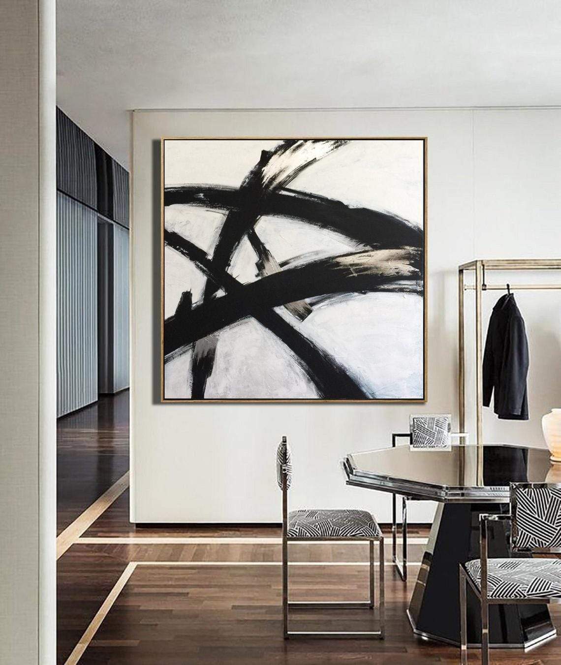 a picture of a black and white painting hanging on a wall