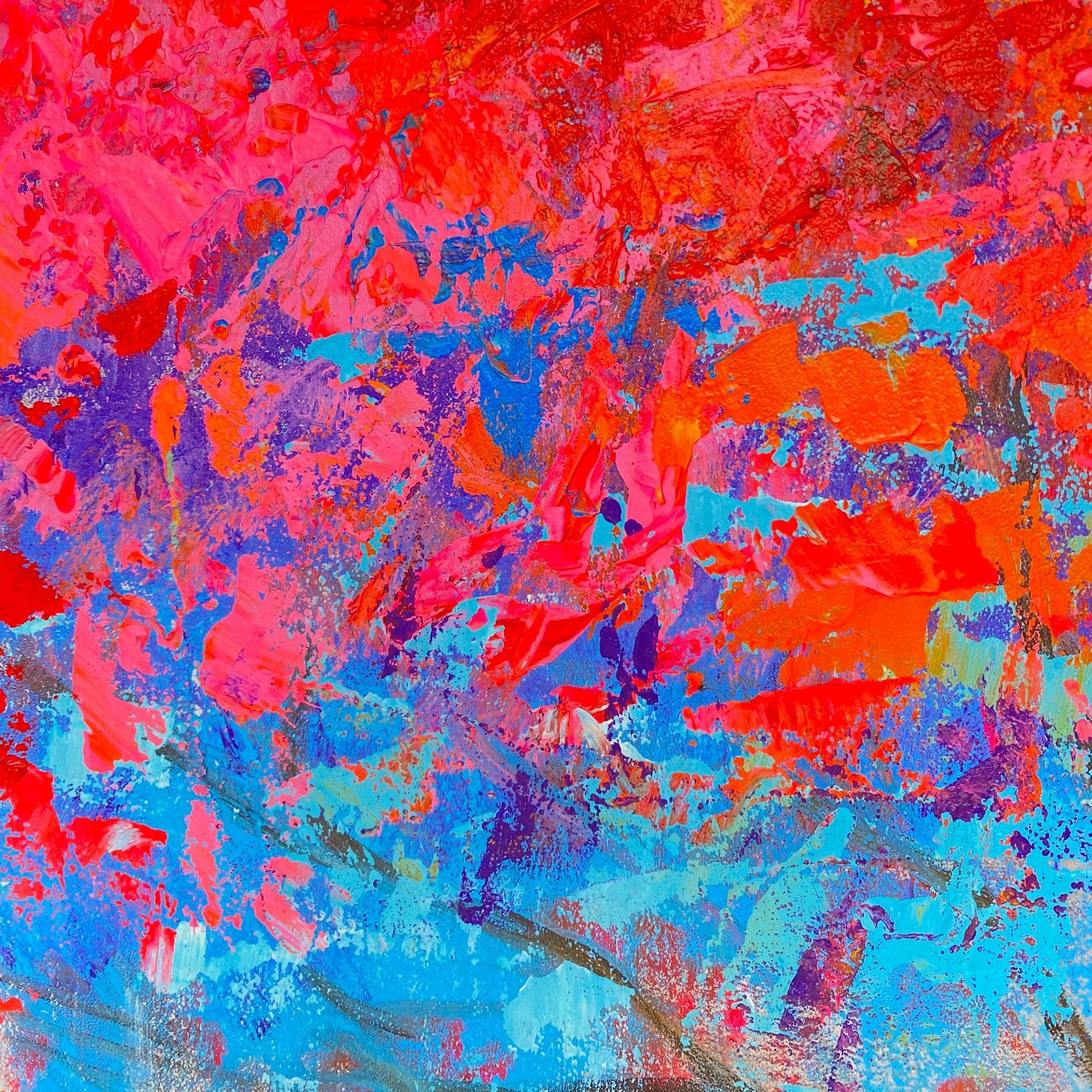 The image is a vibrant abstract painting with bold, bright colors of red, blue, and purple. The painting has a dynamic, expressive style with visible brushstrokes and splatters, creating a sense of movement and energy.