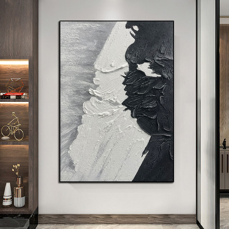 a black and white painting hanging on a wall