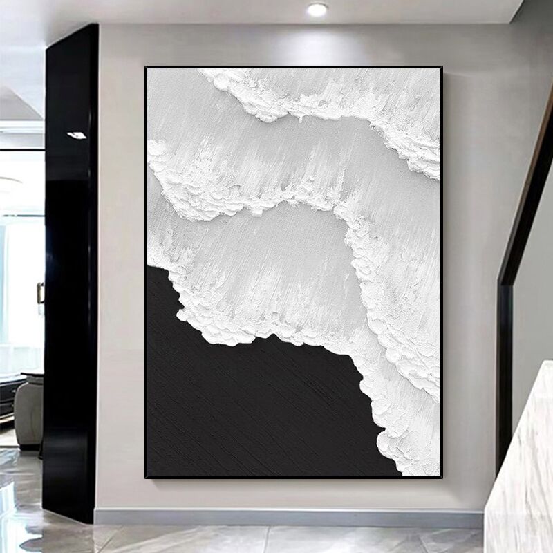 a black and white painting hanging on a wall