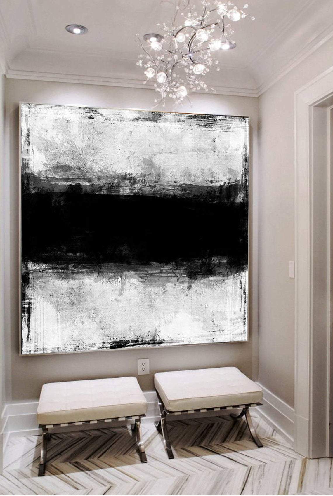 a large black and white painting hanging on a wall