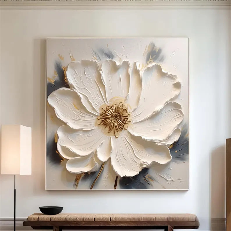a large white flower is hanging on a wall