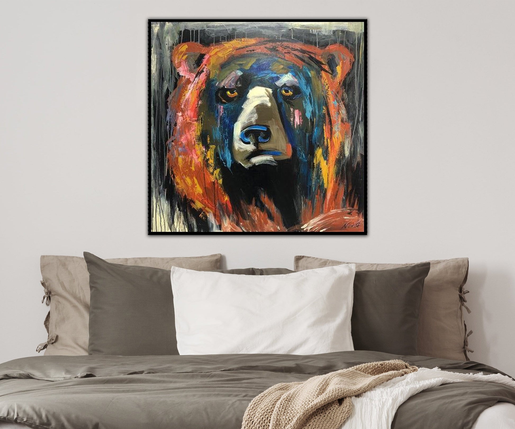 a painting of a bear on a wall above a bed