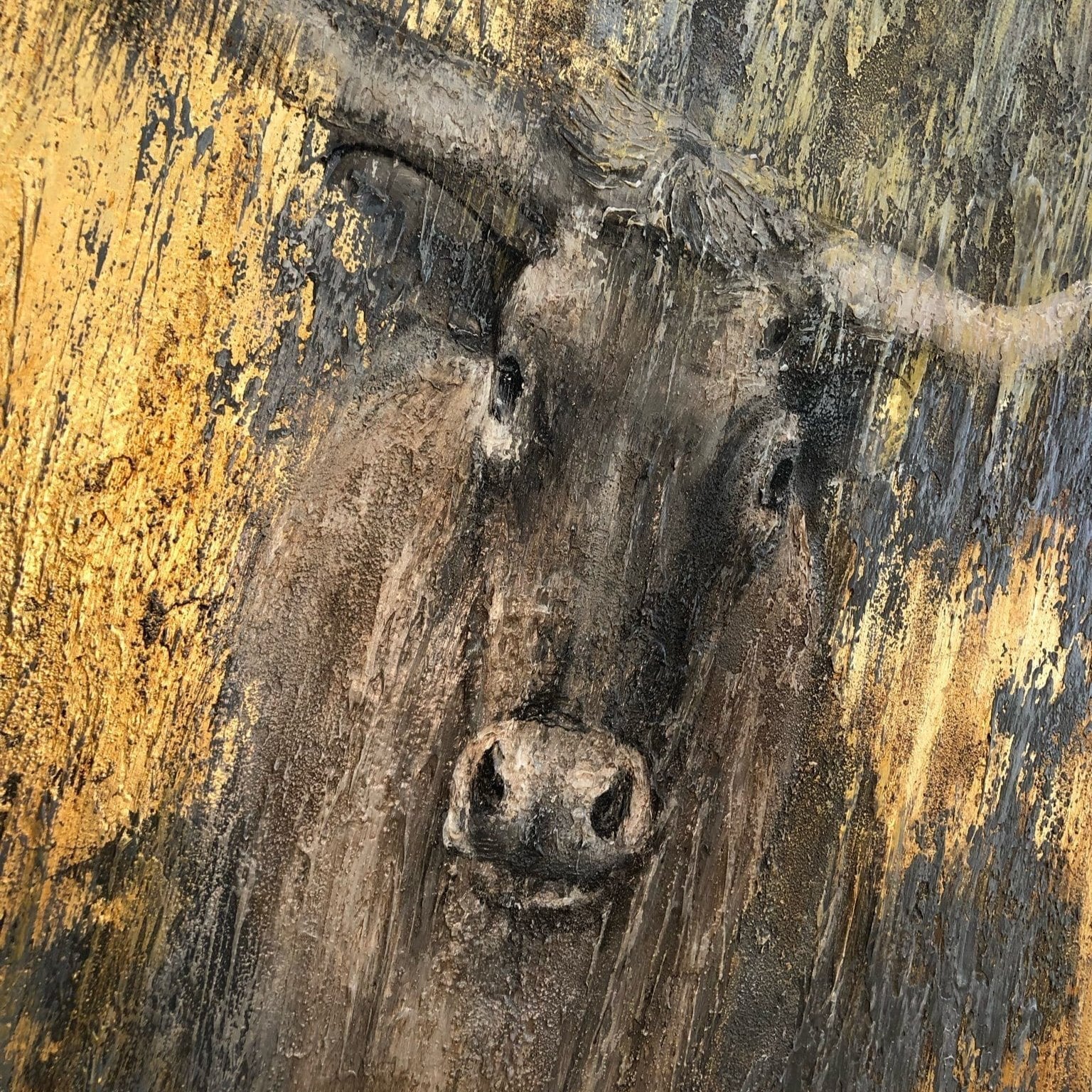 a close-up view of a large, brown animal with a prominent nose, possibly a cow or a bull, against a textured, yellow-toned background.