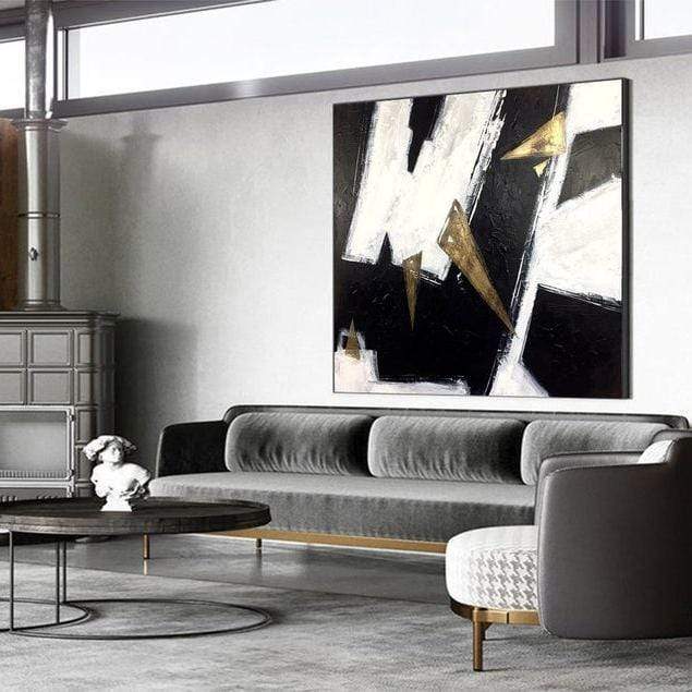 a living room filled with furniture and a painting on the wall