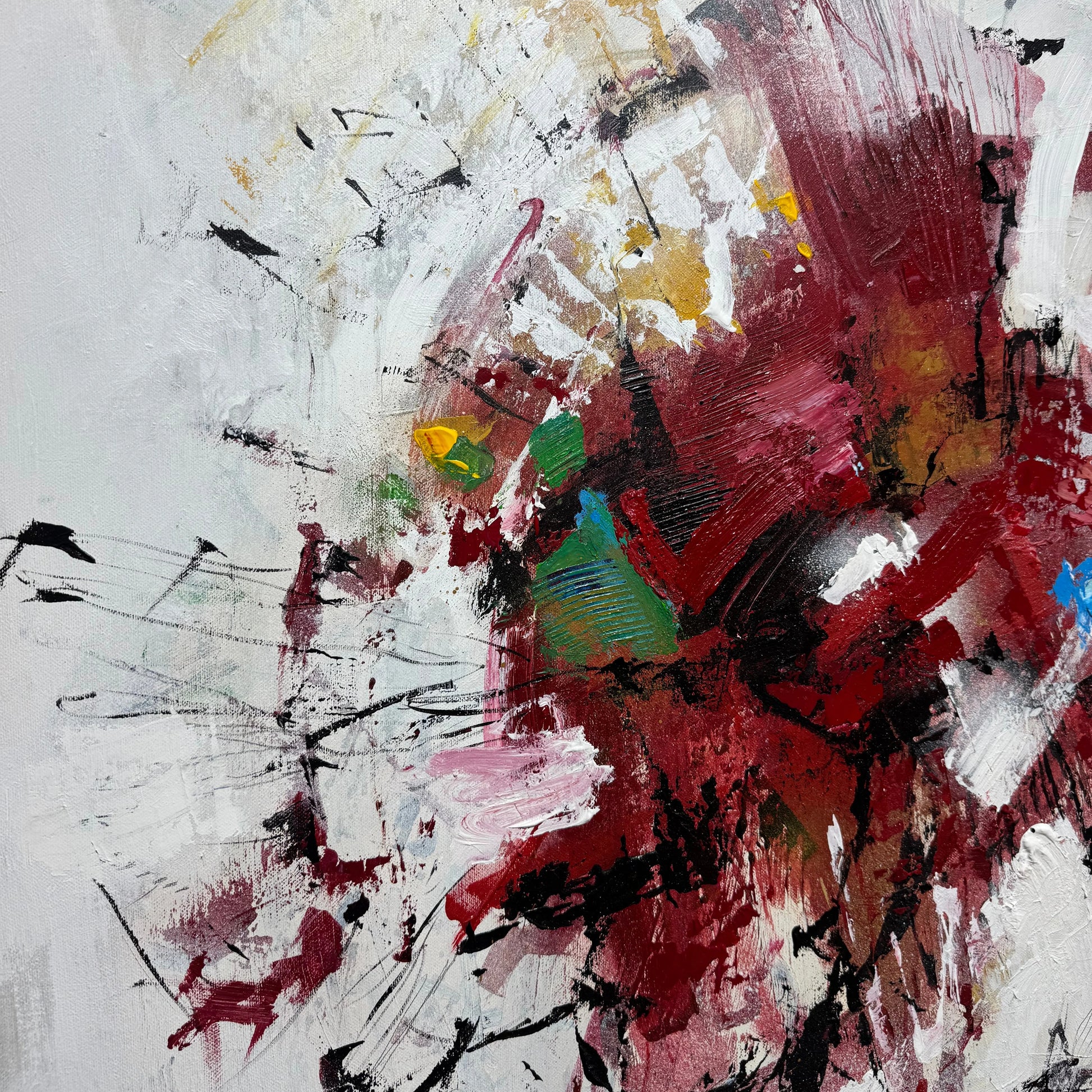 The image is an abstract painting with bold, expressive brushstrokes in various colors, including red, white, and black. The painting appears to be a dynamic and energetic composition, with a sense of movement and energy.