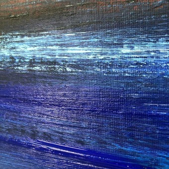 The image is a close-up of a textured surface with a gradient of blue and black colors, creating a visually striking and abstract pattern.