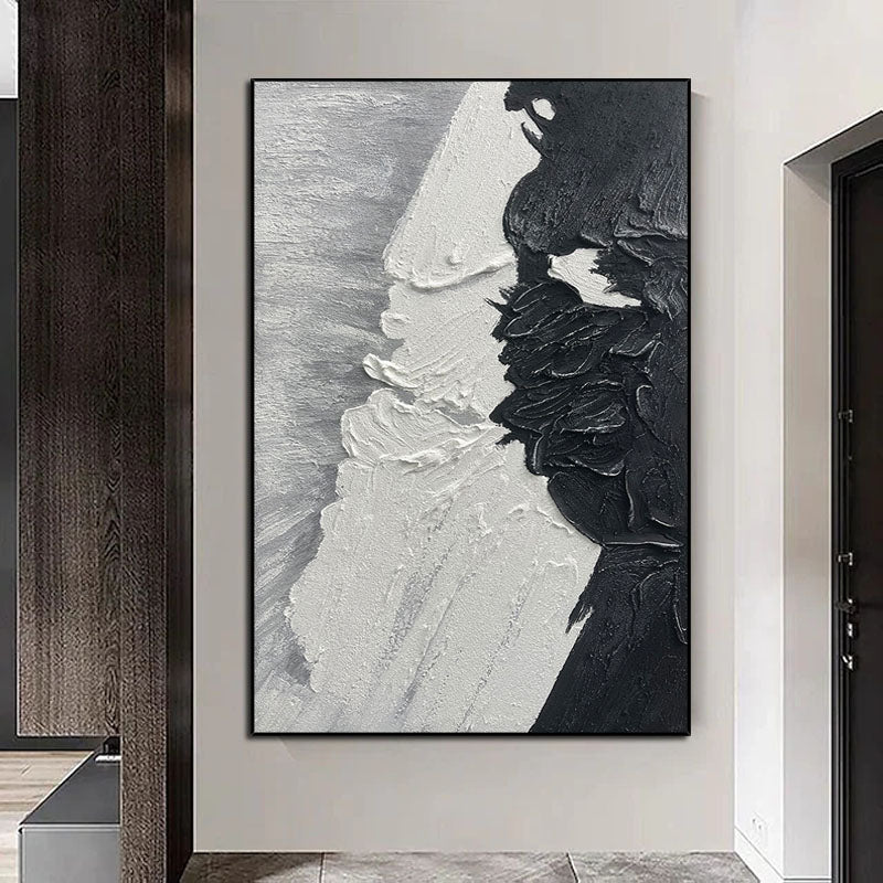 a black and white painting hanging on a wall