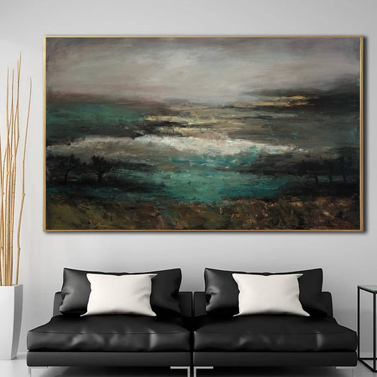 a large, abstract landscape painting hanging on a wall above a black leather sofa with white throw pillows.