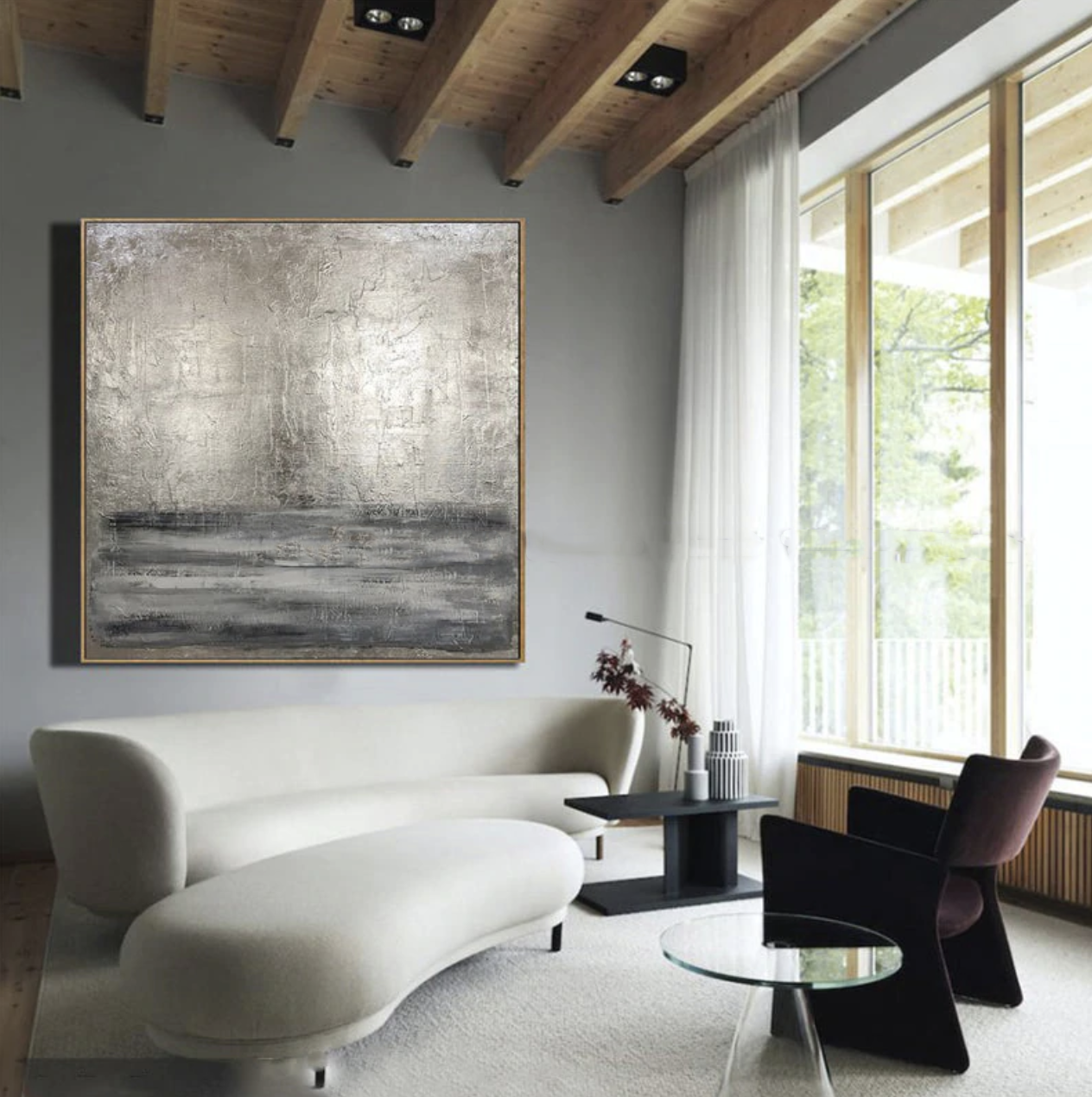 a living room with a large painting on the wall