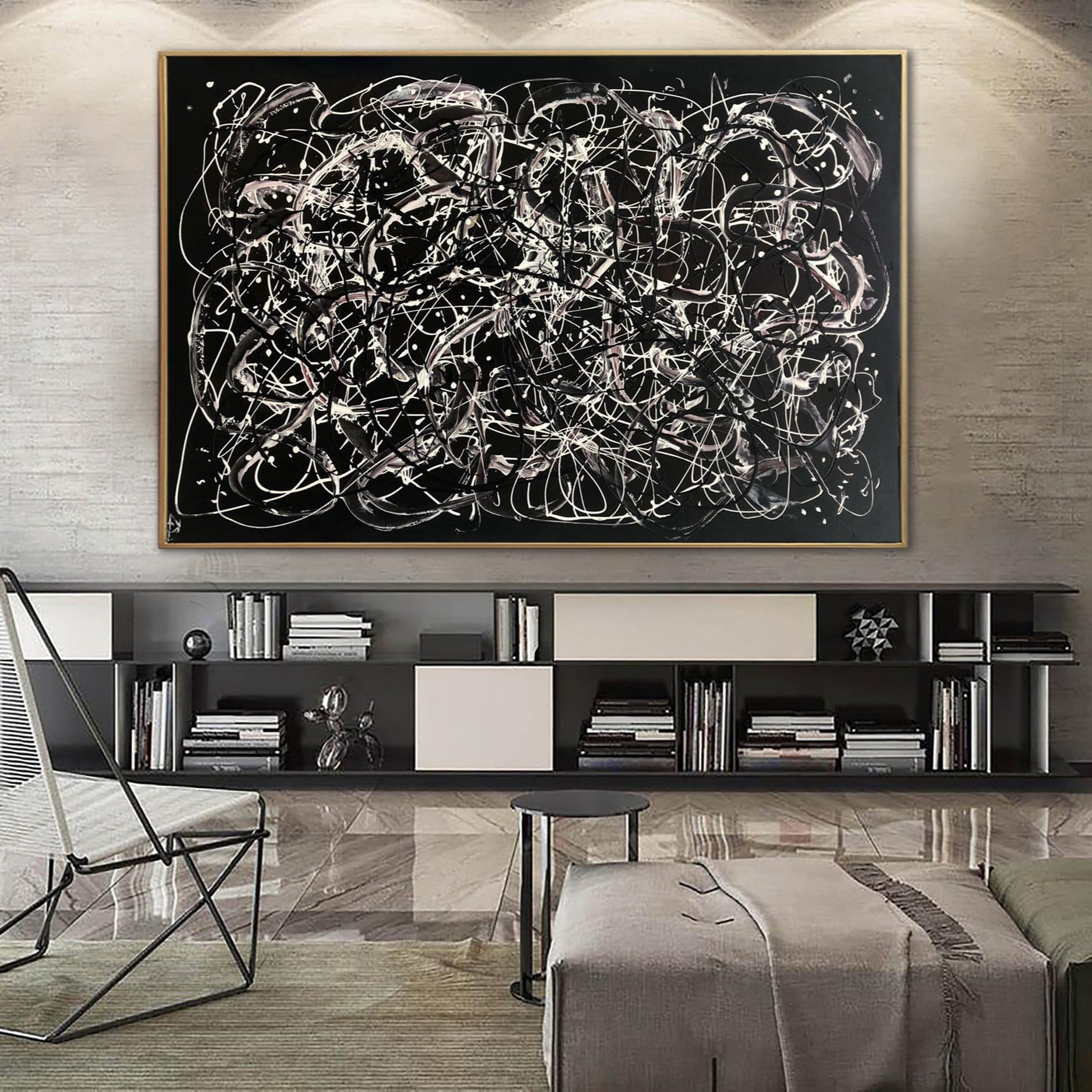 a modern living room with a large abstract painting hanging on the wall above a bookshelf filled with books and various decorative items.