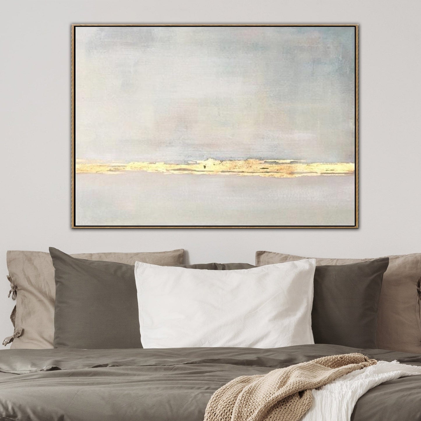 a large abstract painting hanging on a wall above a bed with a gray and white color scheme.