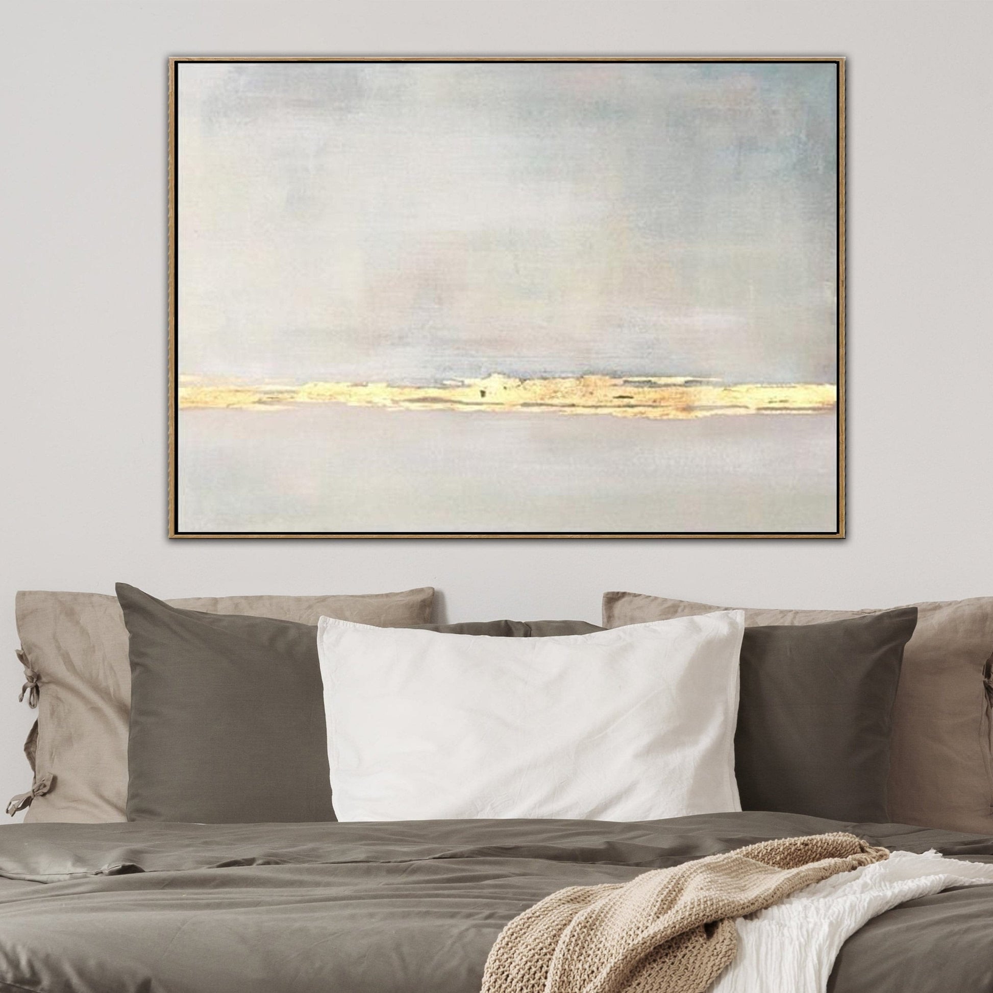 a large abstract painting hanging on a wall above a bed with a gray and white color scheme.