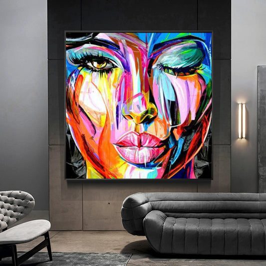 a painting of a woman's face on a wall
