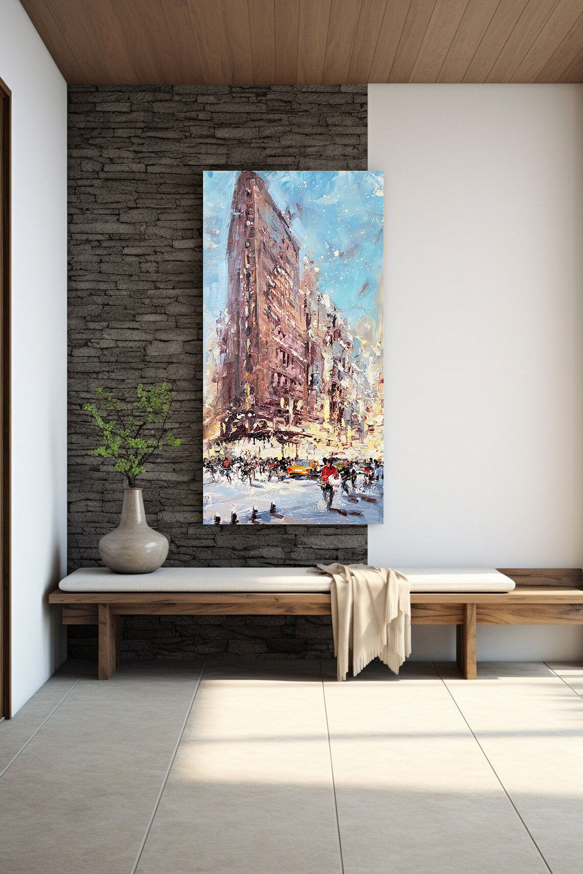 a painting of a cityscape hangs on a wall