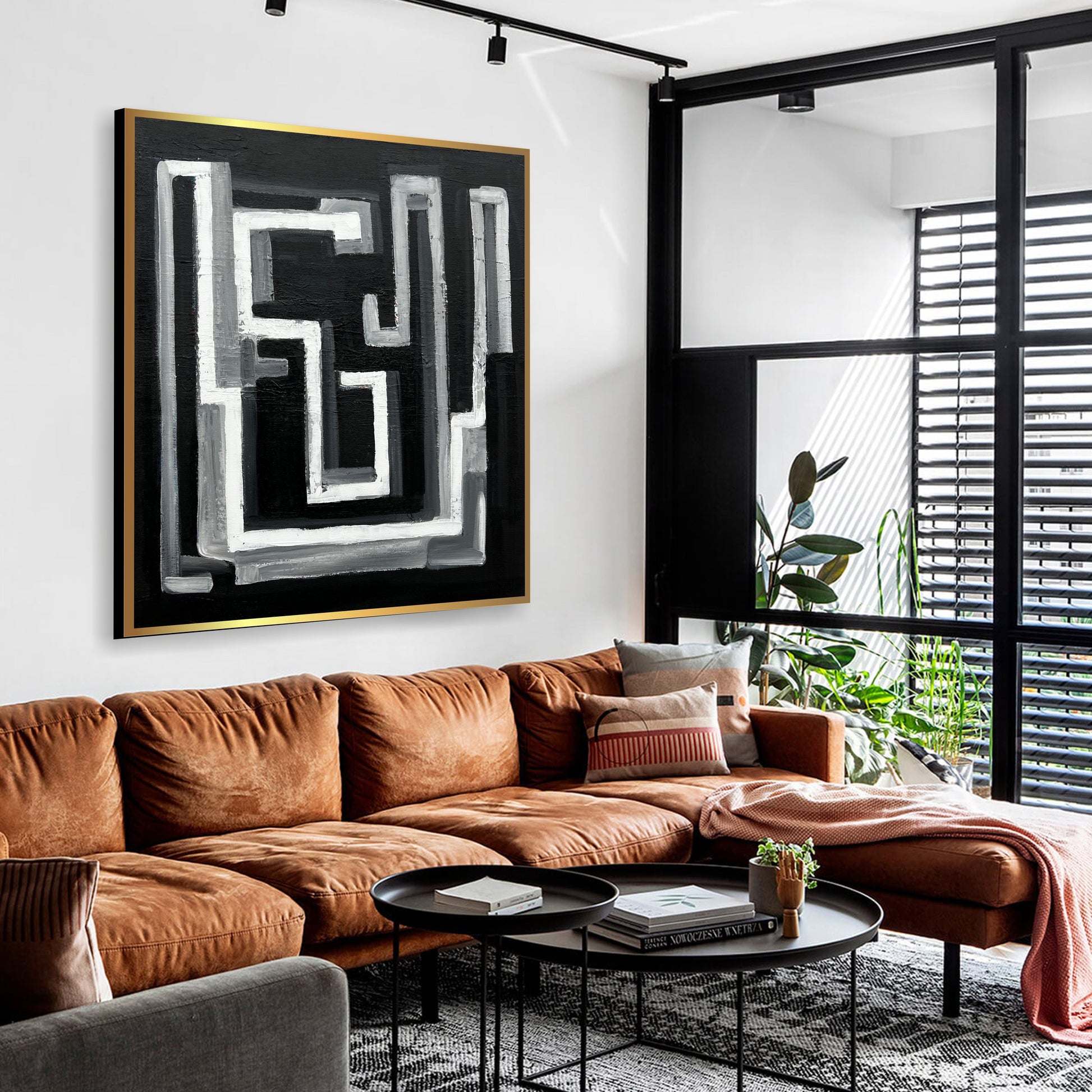 a living room filled with furniture and a painting on the wall