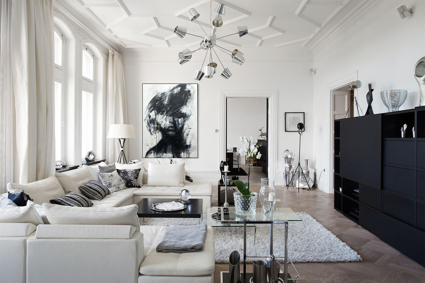 a living room filled with furniture and lots of windows