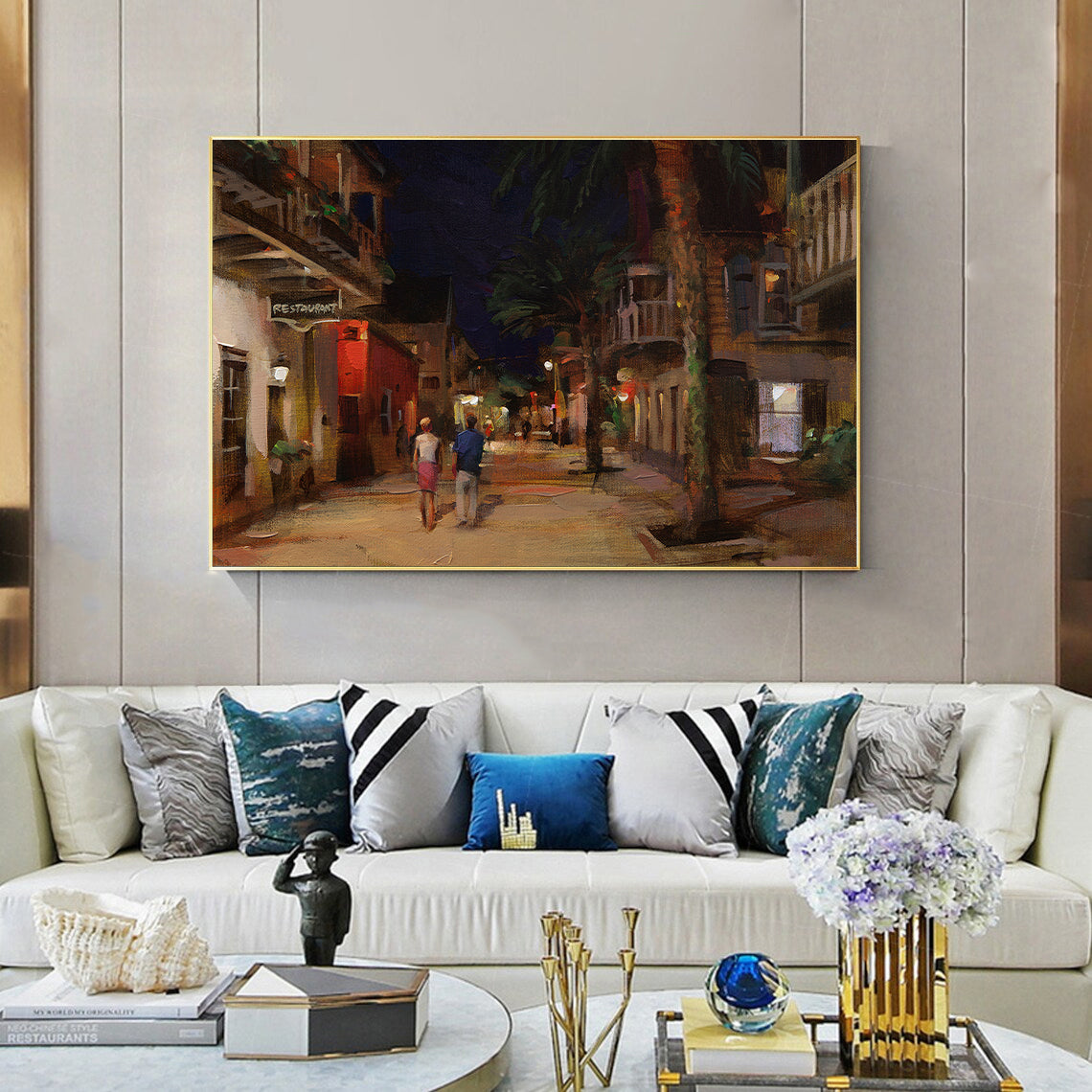 a living room filled with furniture and a painting on the wall