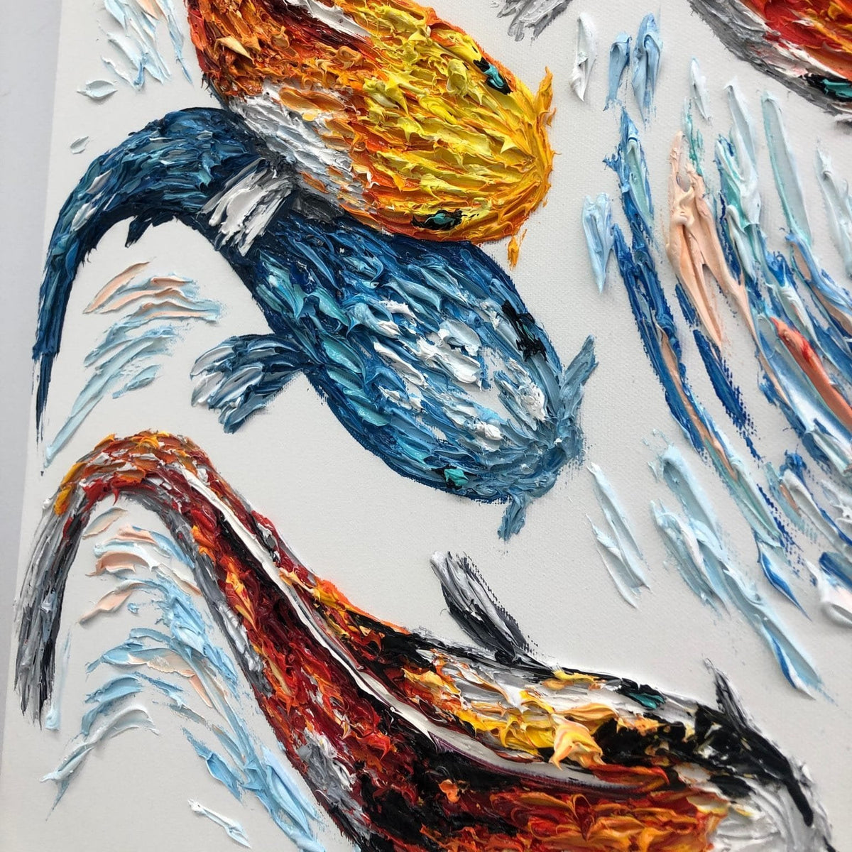 The image is a vibrant painting featuring three fish, each with distinct colors and patterns. The fish are depicted in a dynamic, brushstroke-like style, creating a sense of movement and energy. The painting is a lively and colorful representation of the aquatic life, showcasing the artist's skill and creativity.